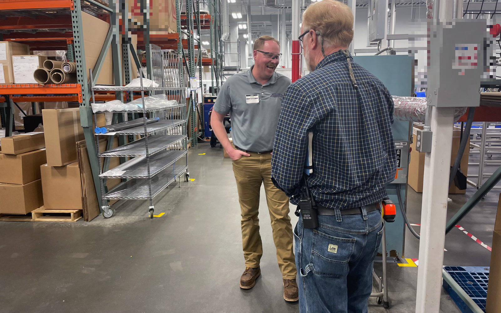Allied continuous-improvement leader working with a client on the floor